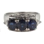 14ct white gold (tested) three stone oval sapphire and round brilliant cut diamond ring