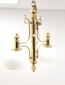 Edwardian style brass two branch light fitting with domed opaque glass shades,