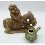Islamic earthenware green glaze whistle and stone tribal carving of a figure on horseback,