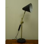 Brass and black finish adjustable desk lamp with cone shaped shade, on circular base,