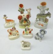 Victorian Staffordshire animals comprising Donkey spill vase, Cow with Milk Maid,