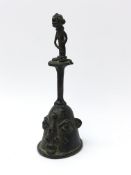 Nigerian Yoruba cast bronze bell with figural handle and mask shaped bell, H17.