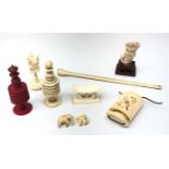 Two 19th century turned bone chess pieces, early 20th century ivory pipe,