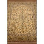 Persian Kashan rug carpet, ivory ground with central medallion, trailing foliage, repeating border,