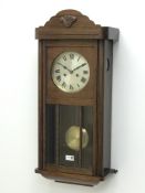 20th century oak cased wall clock, glazed door and silvered dial striking the half hors on a gong,