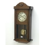 20th century oak cased wall clock, glazed door and silvered dial striking the half hors on a gong,