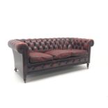 Three seat Chesterfield settee, upholstered in deep buttoned oxblood leather,