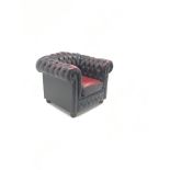 Chesterfield armchair upholstered in deep buttoned oxblood leather,