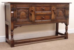 Jacobean style oak sideboard, two carved panel doors flanking two drawers,
