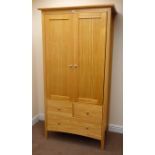 Pine double wardrobe, two doors enclosing hanging rail, two short and one long drawer,