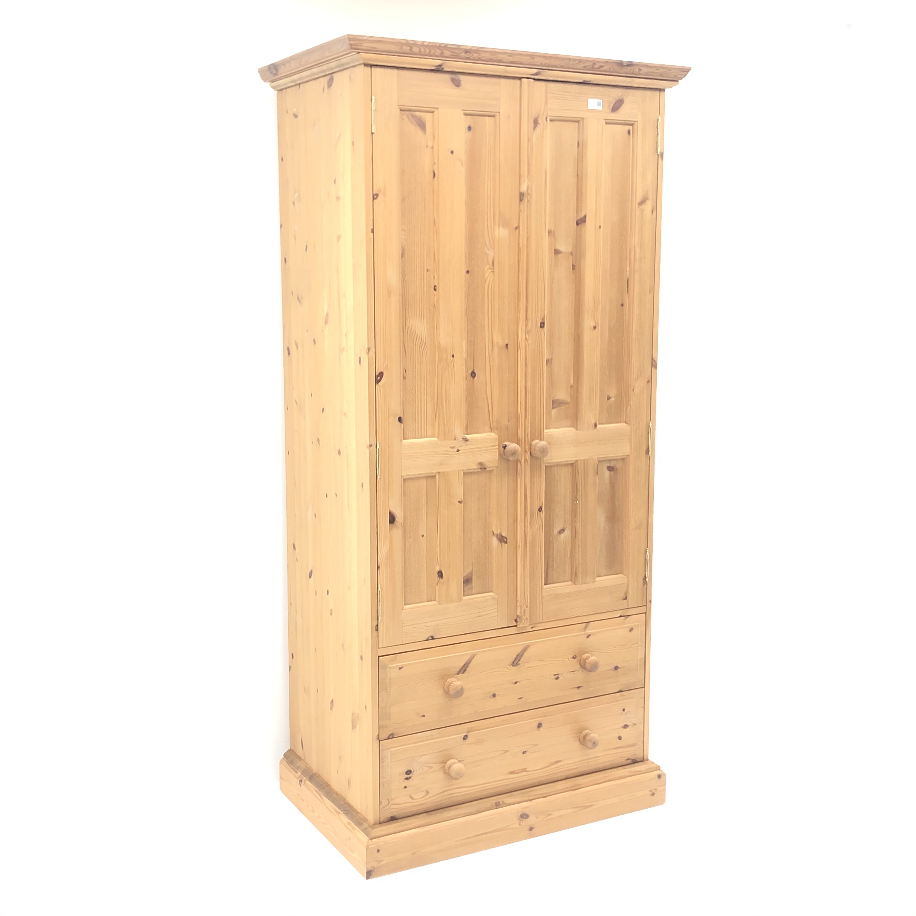 Solid Pine wardrobe, projecting cornice, two doors enclosing fitted interior above two drawers,