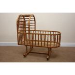 Oak rocking crib, turned spindles with canopy to one end, W61cm, H98cm,