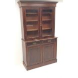 19th century mahogany bookcase on cupboard, two doors enclosing three shelves,