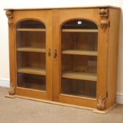 Victorian pine bookcase display cabinet, two arched doors enclosing three shelves, W128cm, H107cm,