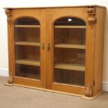 Victorian pine bookcase display cabinet, two arched doors enclosing three shelves, W128cm, H107cm,