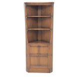 Ercol Golden Dawn finish elm corner cupboard, two shelves above single cupboard, platform base,