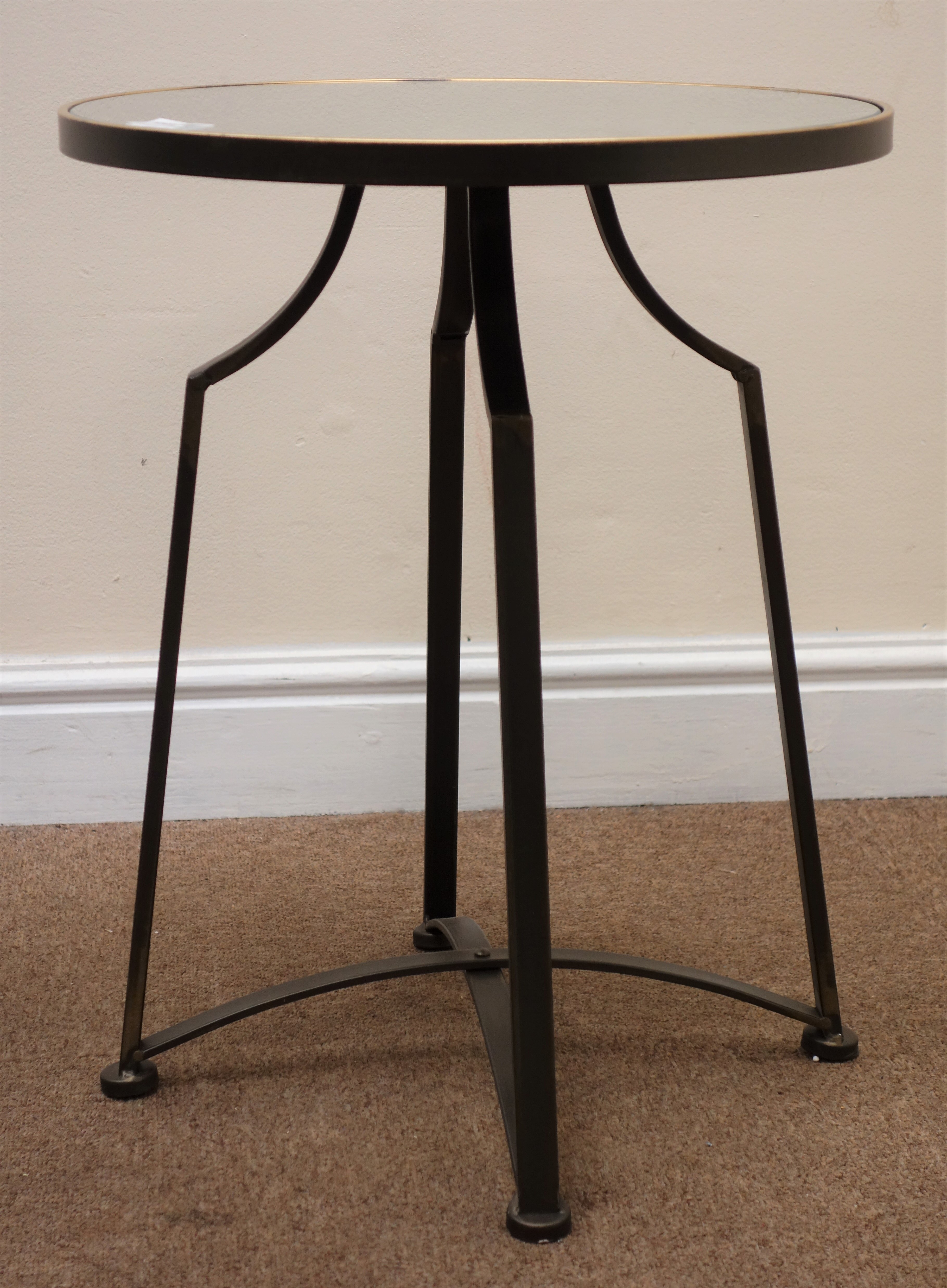 Circular mirror top side table, shaped bronzed metal supports joined by a stretcher, D42cm,