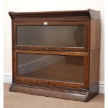 Early 20th century oak two sectional stacking library bookcase, two glazed doors, platform base,