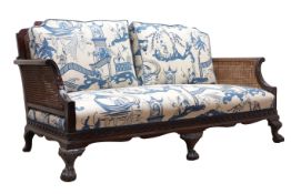 Edwardian George lll style mahogany double caned bergere sofa,