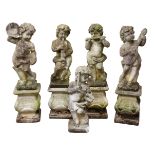 Set of five composite stone cherub musician figures, each playing a different instrument,