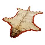 Taxidermy - Early 20th century Tiger skin rug with head mount, glass eyes, limbs outstretched,