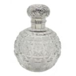 Edwardian silver mounted globular cut glass scent bottle decorated with embossed flowers and