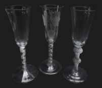 Three ale glasses comprising: round funnel bowl engraved with hops and barley above opaque