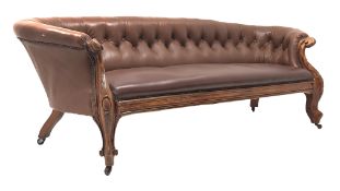 Late 19th century carved walnut framed nailed brown leather upholstered Chesterfield sofa,