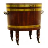 Regency mahogany brass bound oval wine cooler, hinged lid enclosing lead lined interior,