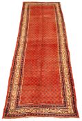 Araak red ground rug, field filled with boteh with a triple stripe geometric border,