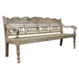 Large hardwood garden bench, baluster turned openwork back with shaped scroll carved top rail,