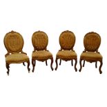 Set of three Victorian walnut and parcel gilt salon chairs, floral carved cresting rail,