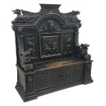 Victorian heavily carved oak settle, panelled back with gryphons and mask heads,