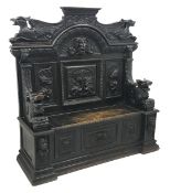 Victorian heavily carved oak settle, panelled back with gryphons and mask heads,