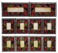 Ten Victorian stained glass panels each having a rectangular frosted glass plate engraved with