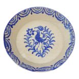 Tin glaze earthenware shallow bowl, central bird painted decoration within stylized border,