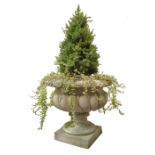 Large composite stone garden urn, wrythen lobed circular body on circular support and square base,
