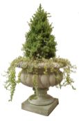 Large composite stone garden urn, wrythen lobed circular body on circular support and square base,