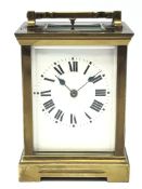Late 19th century brass Carriage clock with white Roman dial, plain case with bevelled glass plates,