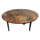 Early 19th century country oak oval drop leaf dining table,