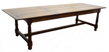 Large oak refectory dining table, panelled top on ring turned supports joined by an H stretcher,