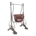 Victorian child's cast iron garden swing, shaped seat on curved supports,