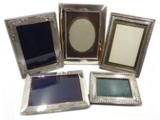 Three hallmarked silver mounted freestanding rectangular photograph frames and two white metal