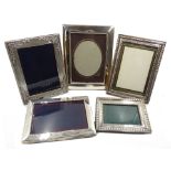 Three hallmarked silver mounted freestanding rectangular photograph frames and two white metal