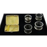 Four silver napkin rings and a silver cigarette case all hallmarked 5oz Condition Report