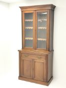 Edwardian walnut bookcase on cupboard, projecting cornice,