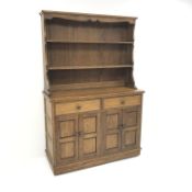 Medium oak dresser with two tier plate rack, two drawers above four cupboard doors, panelled sides,