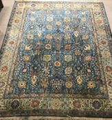 Large Persian style blue ground rug, repeating border,