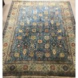 Large Persian style blue ground rug, repeating border,