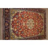 Najaf Abad red ground rug, central medallion, repeating border,